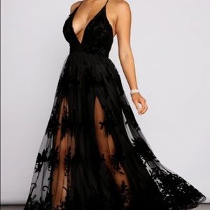 Black evening dress with velvet floral appliqués.